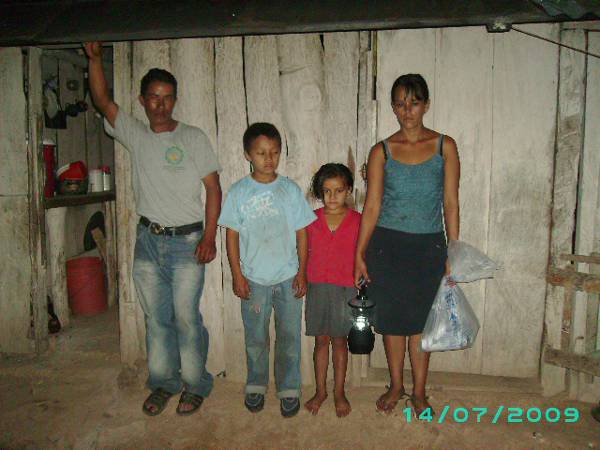 A family outside their home with a lamp